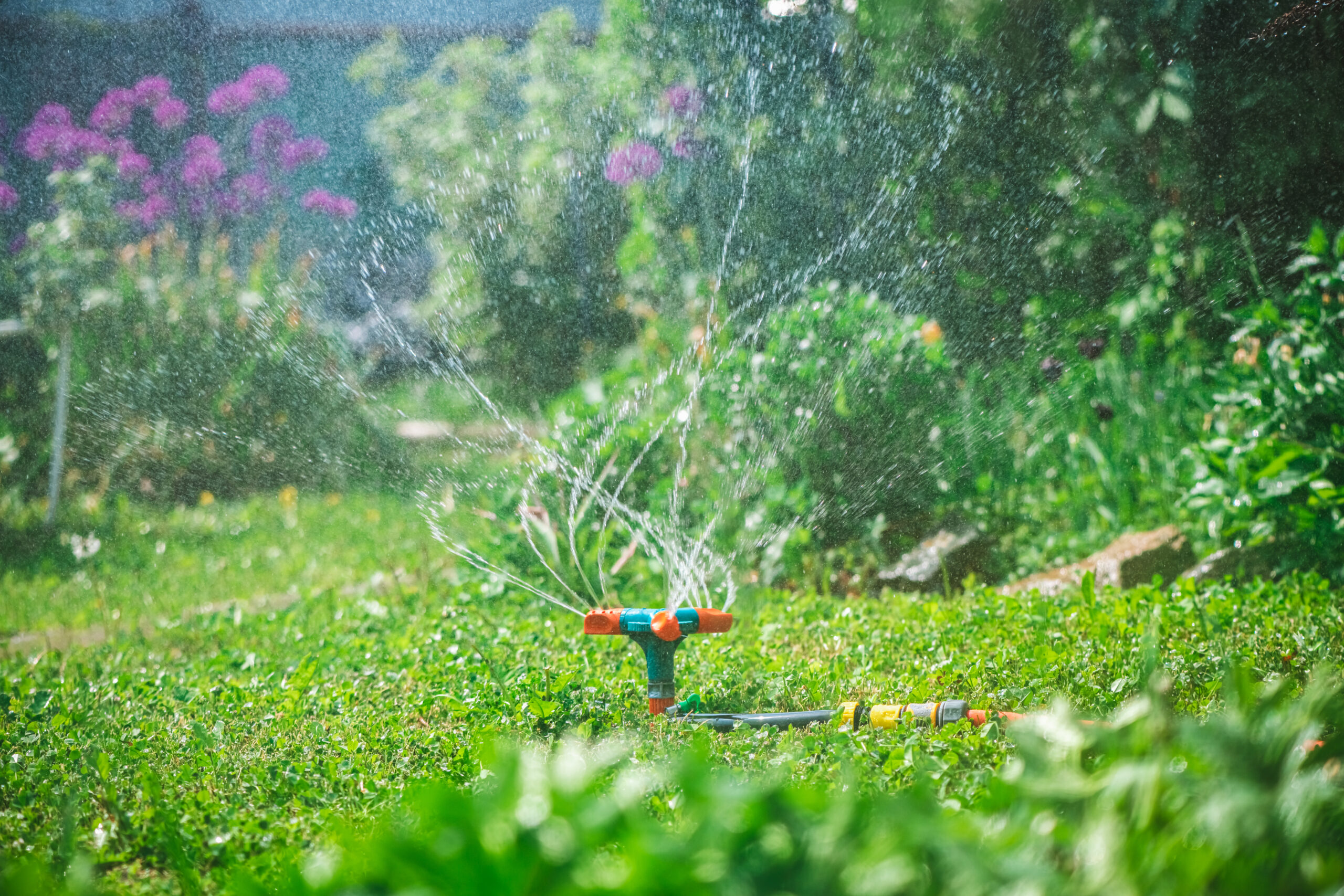 Landscape automatic garden watering system with different rotating sprinklers